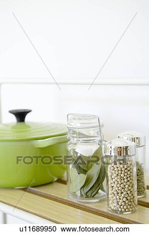 Stock Image - Jars filled with herbs and spices. Fotosearch