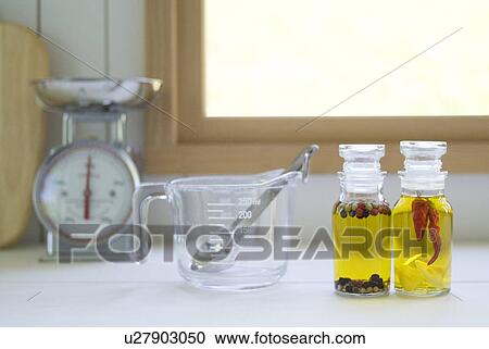 Kitchen utensils and bottles of olive oil with spices View Large Photo Image Stock Image - Kitchen utensils and bottles of olive oil with spices. Fotosearch