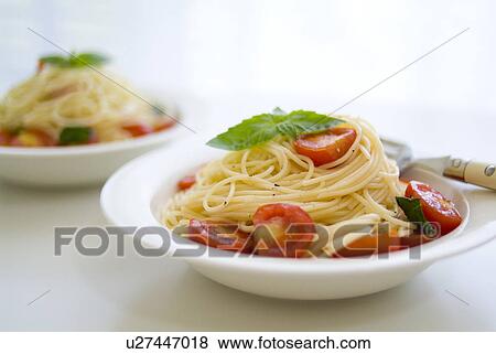 Stock Photo - Spaghetti with tomatoes and basil. Fotosearch