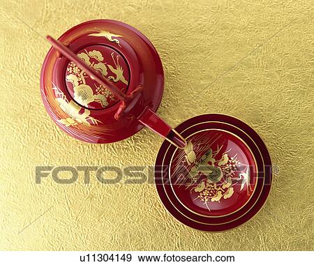 Stock Photo - Lacquered sake pot and cups, high angle view. Fotosearch