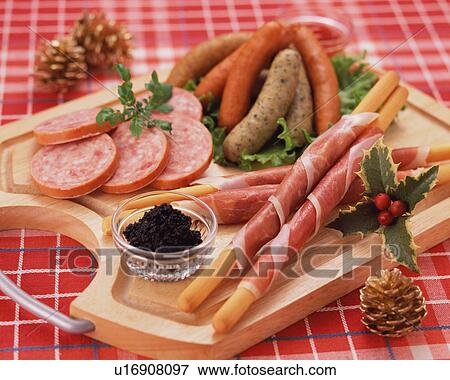 Stock Photo - Assorted ham and sausages on board. Fotosearch