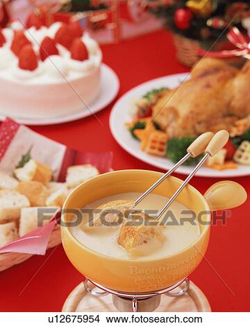 Cheese fondu and roast chicken for Christmas dinner View Large Photo Image Picture - Cheese fondu and roast chicken for Christmas dinner. Fotosearch