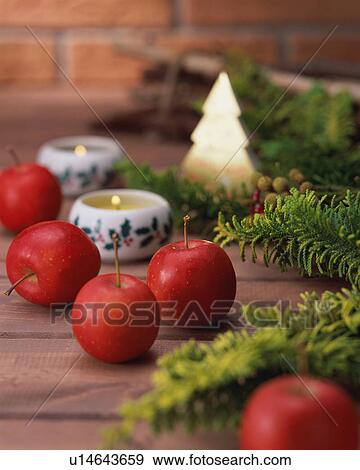 Close up of apples and candles on wooden table View Large Photo Image Stock Photo - Close up of apples and candles on wooden table. Fotosearch