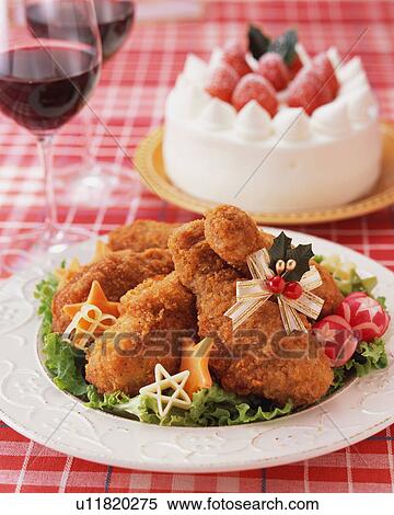 Stock Photography - Fried chicken and strawberry cake for Christmas dinner. Fotosearch