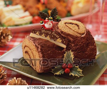 Stock Image - Log shaped chocolate cake for Christmas. Fotosearch