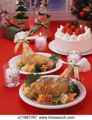 Stock Photo - Roast chicken and strawberry cake served on table. Fotosearch