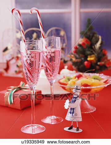 Two champagne glasses with a statuette of a snowman View Large Photo Image Stock Photo - Two champagne glasses with a statuette of a snowman. Fotosearch