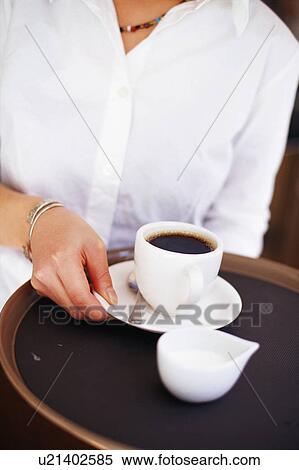 Stock Photography - A young woman sitting in coffee shop. Fotosearch
