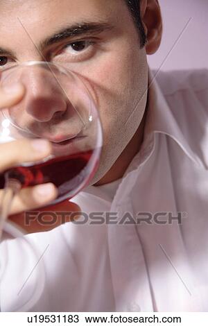 Young man drinking red wine, close up View Large Photo Image Stock Image - Young man drinking red wine, close up. Fotosearch
