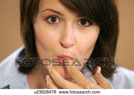 Young woman eating chocolate candy, portrait, close up View Large Photo Image Stock Photograph - Young woman eating chocolate candy, portrait, close up. Fotosearch