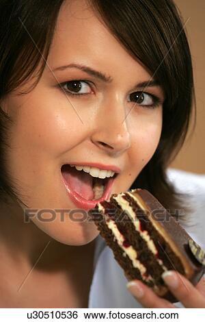 Young woman eating slice of chocolate cake, portrait, close up View Large Photo Image Stock Photograph - Young woman eating slice of chocolate cake, portrait, close up. Fotosearch