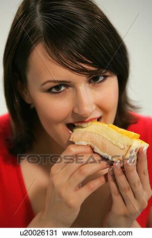 Young woman eating slice of fruit pie with her fingers, portrait, close up View Large Photo Image Stock Image - Young woman eating slice of fruit pie with her fingers, portrait, close up. Fotosearch