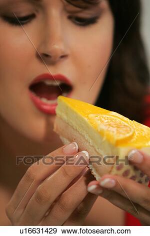 Young woman eating slice of fruit pie with her fingers, portrait, close up View Large Photo Image Stock Photo - Young woman eating slice of fruit pie with her fingers, portrait, close up. Fotosearch