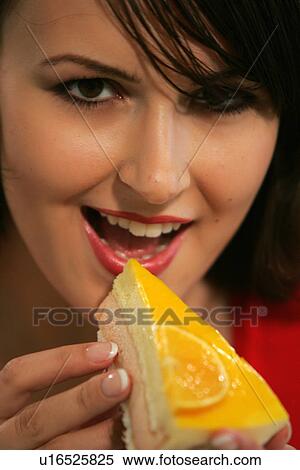 Young woman eating slice of fruit pie with her fingers, portrait, close up View Large Photo Image Stock Photography - Young woman eating slice of fruit pie with her fingers, portrait, close up. Fotosearch
