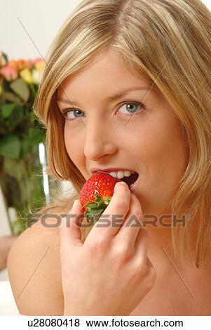 Portrait of Woman eating strawberry View Large Photo Image Stock Photo - Portrait of Woman eating strawberry. Fotosearch
