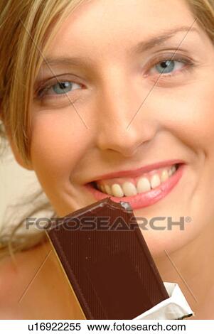 Stock Photography - Portrait of Woman with chocolate bar. Fotosearch