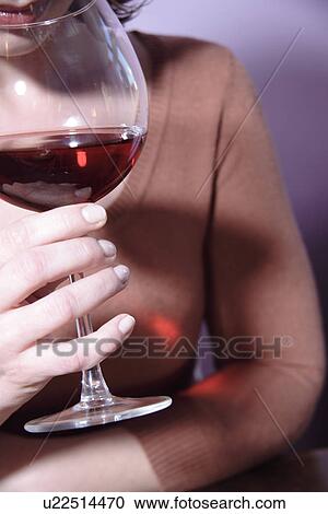 Stock Image - Woman drinking red wine, close up. Fotosearch