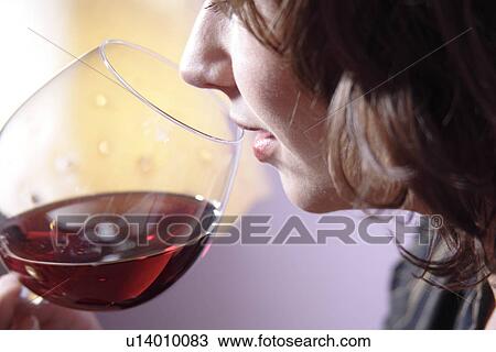 Woman with glass of red wine, smelling, close up View Large Photo Image Stock Image - Woman with glass of red wine, smelling, close up. Fotosearch
