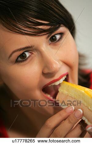 Young woman eating slice of fruit pie with her fingers, portrait, close up View Large Photo Image Stock Photography - Young woman eating slice of fruit pie with her fingers, portrait, close up. Fotosearch
