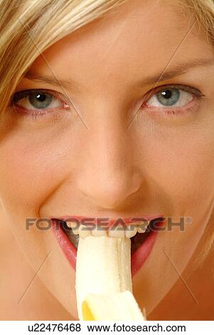 Close-up of Woman eating banana View Large Photo Image Stock Photo - Close-up of Woman eating banana. Fotosearch