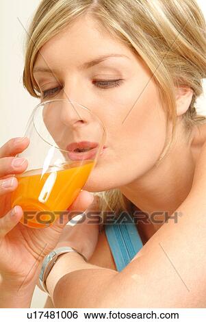 Portrait of Woman drinking juice View Large Photo Image Stock Photograph - Portrait of Woman drinking juice. Fotosearch
