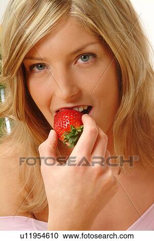 Portrait of Woman eating strawberry View Large Photo Image Stock Image - Portrait of Woman eating strawberry. Fotosearch