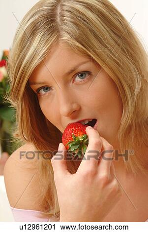 Portrait of Woman eating strawberry View Large Photo Image Stock Image - Portrait of Woman eating strawberry. Fotosearch