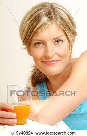 Portrait of Woman holding glass of juice View Large Photo Image Picture - Portrait of Woman holding glass of juice. Fotosearch