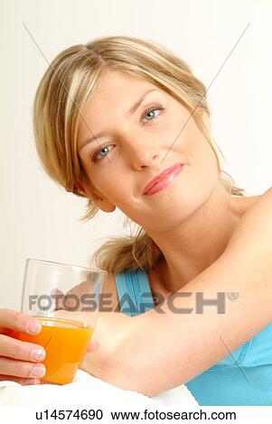 Portrait of Woman holding glass of juice View Large Photo Image Stock Image - Portrait of Woman holding glass of juice. Fotosearch