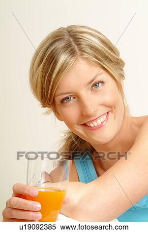 Portrait of Woman holding glass of juice View Large Photo Image Stock Photography - Portrait of Woman holding glass of juice. Fotosearch