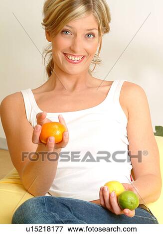 Woman holding citrus fruit View Large Photo Image Stock Photo - Woman holding citrus fruit. Fotosearch