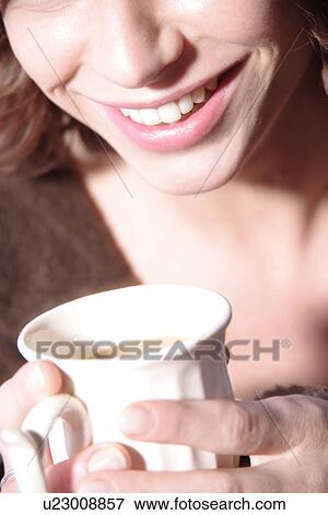 Stock Photo - Woman holding cup of coffee, close up. Fotosearch