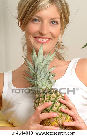Stock Photo - Woman with pineapple. Fotosearch