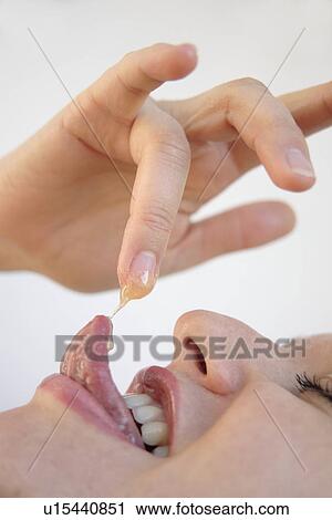 Young blond woman licking honey off her finger, side view, close up View Large Photo Image Stock Image - Young blond woman licking honey off her finger, side view, close up. Fotosearch