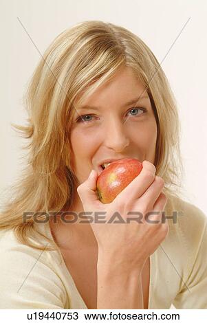 Portrait of Woman eating apple, biting off View Large Photo Image Stock Image - Portrait of Woman eating apple, biting off. Fotosearch