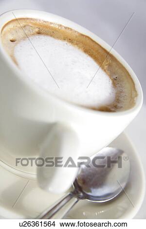 Picture - Cup of cappuccino with milk froth, close up. Fotosearch