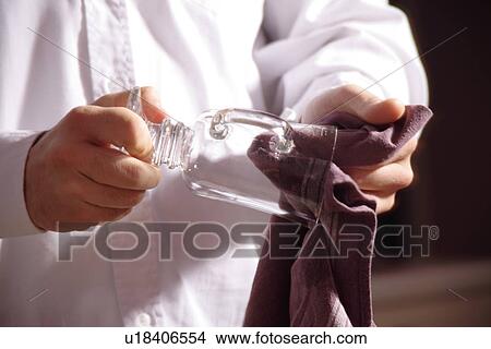 Picture - Male hands drying glass, close up. Fotosearch