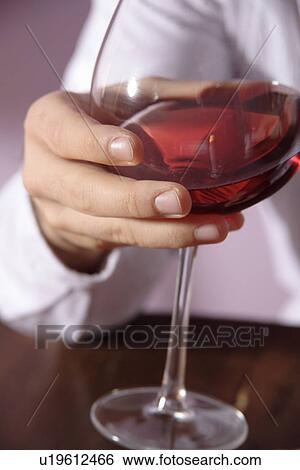 Man swirling red wine in glass, close up View Large Photo Image Stock Photograph - Man swirling red wine in glass, close up. Fotosearch