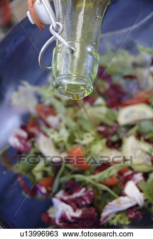 Preparing fresh salad: adding olive oil View Large Photo Image Stock Image - Preparing fresh salad: adding olive oil. Fotosearch