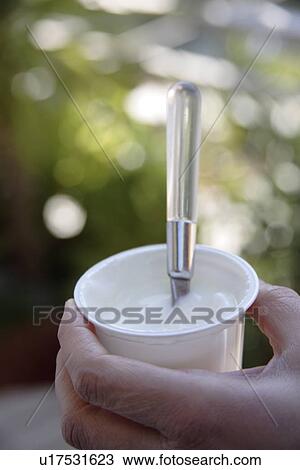 Woman eating yogurt, close up View Large Photo Image Stock Image - Woman eating yogurt, close up. Fotosearch