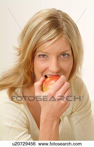 Portrait of Woman eating apple, biting off View Large Photo Image Stock Photograph - Portrait of Woman eating apple, biting off. Fotosearch