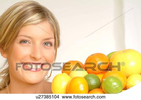Picture - Portrait of Woman with bowl of citrus fruit. Fotosearch