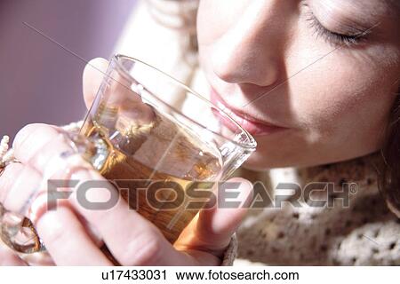 Woman drinking glass mug of tea, close up View Large Photo Image Stock Image - Woman drinking glass mug of tea, close up. Fotosearch