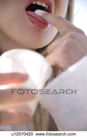 Woman licking yogurt off her finger, close up View Large Photo Image Stock Image - Woman licking yogurt off her finger, close up. Fotosearch