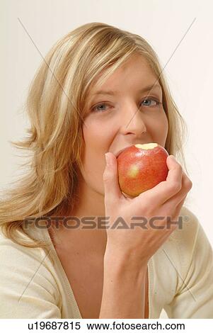 Portrait of Woman eating apple, biting off View Large Photo Image Stock Photography - Portrait of Woman eating apple, biting off. Fotosearch