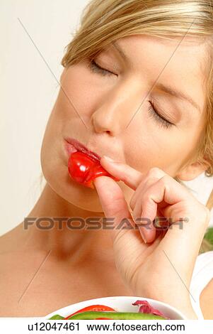 Portrait of woman eating red pepper View Large Photo Image Stock Image - Portrait of woman eating red pepper. Fotosearch