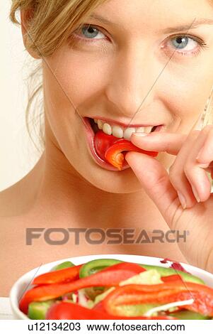 Portrait of woman eating red pepper View Large Photo Image Stock Image - Portrait of woman eating red pepper. Fotosearch