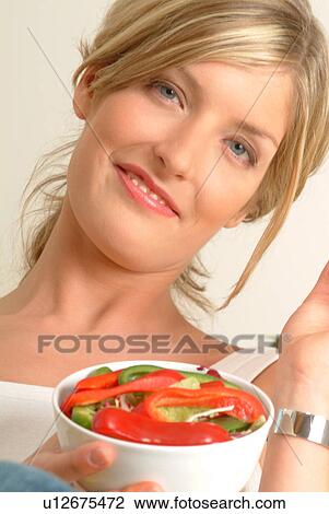 Portrait of Woman eating red pepper View Large Photo Image Stock Image - Portrait of Woman eating red pepper. Fotosearch