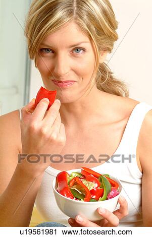 Portrait of woman eating red pepper View Large Photo Image Stock Image - Portrait of woman eating red pepper. Fotosearch