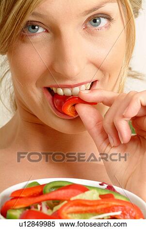 Portrait of woman eating red pepper View Large Photo Image Stock Photography - Portrait of woman eating red pepper. Fotosearch